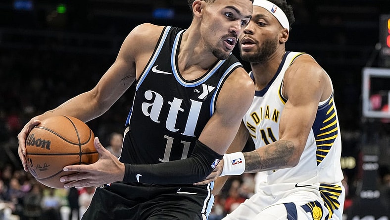 Nov 21, 2023; Atlanta, Georgia, USA; Atlanta Hawks guard Trae Young (11) tries to get past Indiana Pacers forward Bruce Brown (11) during the second half at State Farm Arena. Mandatory Credit: Dale Zanine-USA TODAY Sports