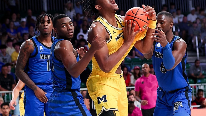 Nov 22, 2023; Paradise Island, BAHAMAS;  Michigan Wolverines forward Tarris Reed Jr. (32) controls the ball as Memphis Tigers guard Jayhlon Young (1) and Memphis Tigers forward David Jones (8) defend during the first half at Imperial Arena. Mandatory Credit: Kevin Jairaj-USA TODAY Sports
