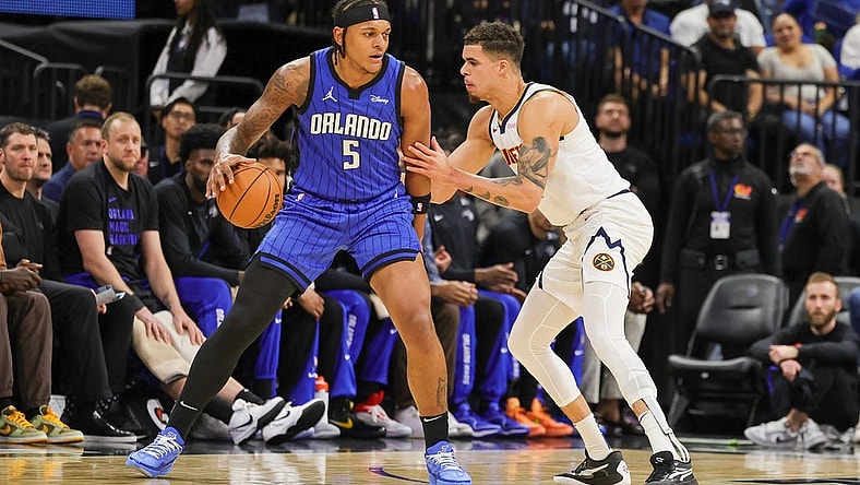 Nov 22, 2023; Orlando, Florida, USA; Denver Nuggets forward Michael Porter Jr. (1) defends Orlando Magic forward Paolo Banchero (5) during the first quarter at Amway Center. Mandatory Credit: Mike Watters-USA TODAY Sports