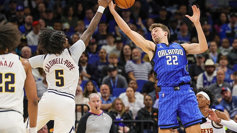 Nov 22, 2023; Orlando, Florida, USA; Orlando Magic forward Franz Wagner (22) and Denver Nuggets guard Kentavious Caldwell-Pope (5) battle for the ball during the second quarter at Amway Center. Mandatory Credit: Mike Watters-USA TODAY Sports