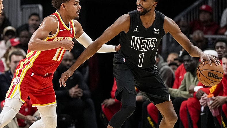 Nov 22, 2023; Atlanta, Georgia, USA; Atlanta Hawks guard Trae Young (11) defends against Brooklyn Nets forward Mikal Bridges (1) during the first half at State Farm Arena. Mandatory Credit: Dale Zanine-USA TODAY Sports