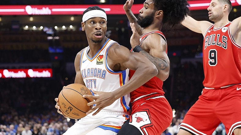 Nov 22, 2023; Oklahoma City, Oklahoma, USA; Oklahoma City Thunder guard Shai Gilgeous-Alexander (2) is defended by Chicago Bulls guard Coby White (0) on a drive to the basket during the second quarter at Paycom Center. Mandatory Credit: Alonzo Adams-USA TODAY Sports