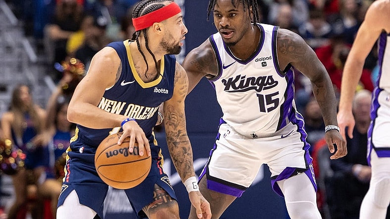 Nov 22, 2023; New Orleans, Louisiana, USA; New Orleans Pelicans guard Jose Alvarado (15) dribbles against Sacramento Kings guard Davion Mitchell (15) during the first half at the Smoothie King Center. Mandatory Credit: Stephen Lew-USA TODAY Sports