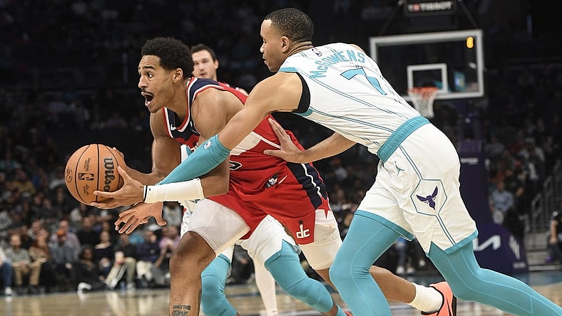 Nov 22, 2023; Charlotte, North Carolina, USA; Washington Wizards guard Jordan Poole (13) drives past Charlotte Hornets guard Bryce McGowens (7) during the second half at the Spectrum Center. Mandatory Credit: Sam Sharpe-USA TODAY Sports
