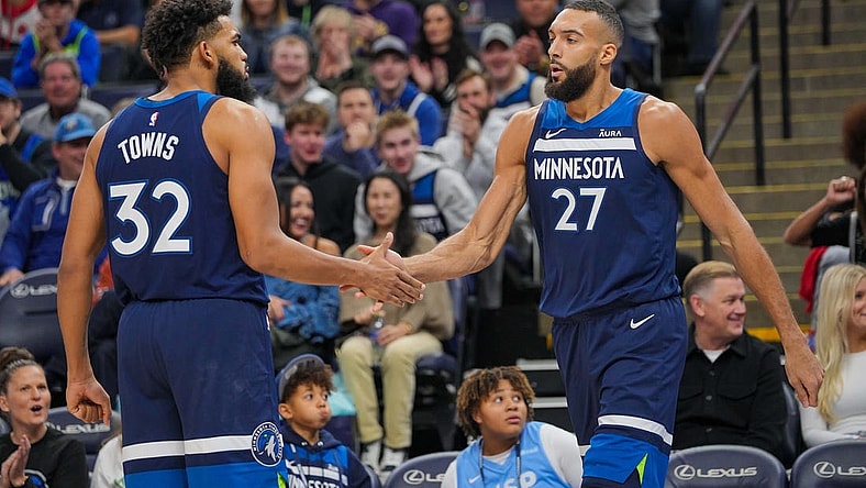 Nov 22, 2023; Minneapolis, Minnesota, USA; Minnesota Timberwolves center Karl-Anthony Towns (32) congratulates center Rudy Gobert (27) against the Philadelphia 76ers in the third quarter at Target Center. Mandatory Credit: Brad Rempel-USA TODAY Sports