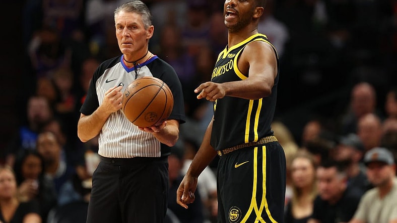 Nov 22, 2023; Phoenix, Arizona, USA; Golden State Warriors guard Chris Paul (3) alongside NBA referee Scott Foster against the Phoenix Suns in the first half at Footprint Center. Mandatory Credit: Mark J. Rebilas-USA TODAY Sports