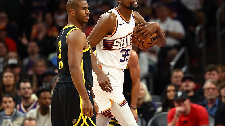 Nov 22, 2023; Phoenix, Arizona, USA; Phoenix Suns forward Kevin Durant (35) alongside Golden State Warriors guard Chris Paul (3) in the first half at Footprint Center. Mandatory Credit: Mark J. Rebilas-USA TODAY Sports