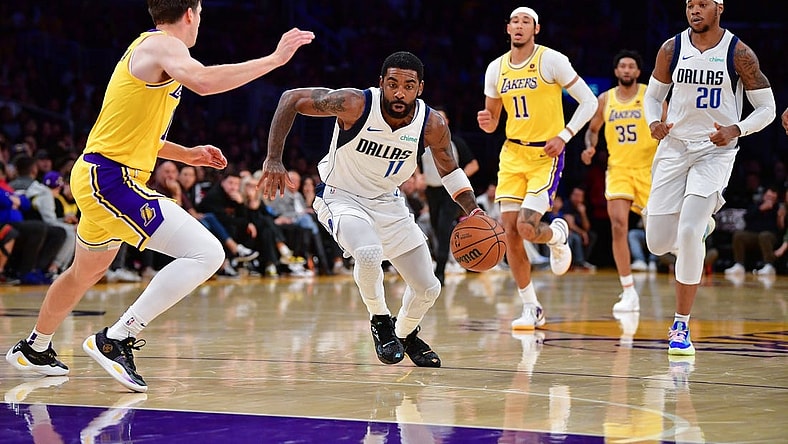 Nov 22, 2023; Los Angeles, California, USA; Dallas Mavericks guard Kyrie Irving (11) moves to the basket against Los Angeles Lakers guard Austin Reaves (15) during the first half at Crypto.com Arena. Mandatory Credit: Gary A. Vasquez-USA TODAY Sports