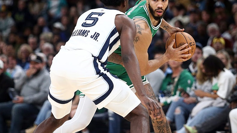Nov 19, 2023; Memphis, Tennessee, USA; Boston Celtics forward Jayson Tatum (0) handles the ball as Memphis Grizzlies guard Vince Williams Jr. (5) defends during the first half at FedExForum. Mandatory Credit: Petre Thomas-USA TODAY Sports