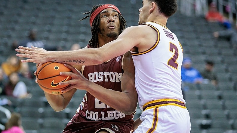 Nov 23, 2023; Kansas City, Missouri, USA; Boston College Eagles forward Devin McGlockton (21) tries to get around Loyola (Il) Ramblers guard Jalen Quinn (2) during the first half at T-Mobile Center. Mandatory Credit: William Purnell-USA TODAY Sports