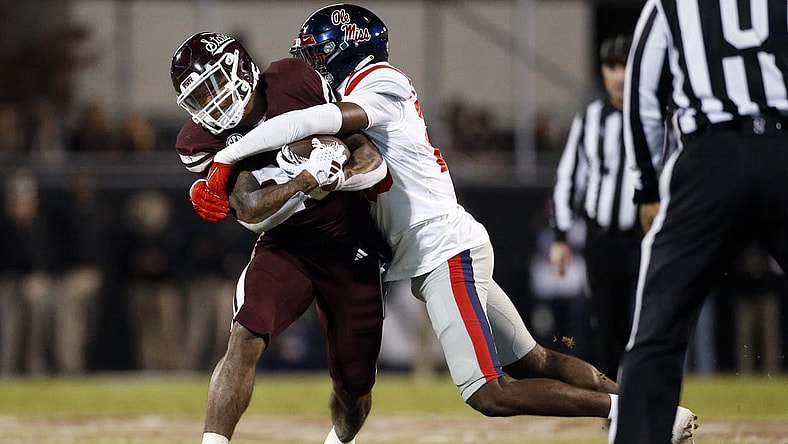 Nov 23, 2023; Starkville, Mississippi, USA; Mississippi State Bulldogs running back Jeffery Pittman (25) runs the ball as Mississippi Rebels linebacker Khari Coleman (23) makes the tackle during the first half at Davis Wade Stadium at Scott Field. Mandatory Credit: Petre Thomas-USA TODAY Sports