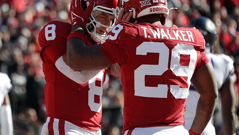 Nov 24, 2023; Norman, Oklahoma, USA; Oklahoma Sooners quarterback Dillon Gabriel (8) celebrates with running back Gavin Sawchuk (27) after a touchdown during the game against the TCU Horned Frogs  at Gaylord Family-Oklahoma Memorial Stadium. Mandatory Credit: Bryan Terry-USA TODAY Sports