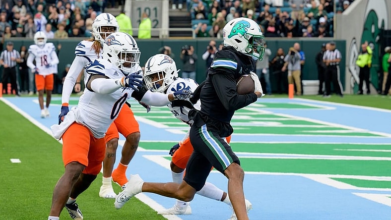 Nov 24, 2023; New Orleans, Louisiana, USA; Tulane Green Wave wide receiver Chris Brazzell II (17) runs around UTSA Roadrunners defensive back Ken Robinson (21) for a touchdown during the first half at Yulman Stadium. Mandatory Credit: Matthew Hinton-USA TODAY Sports