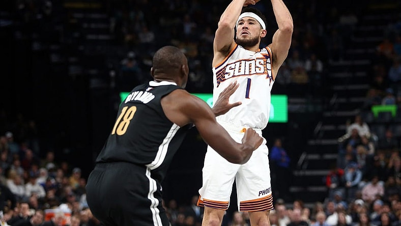 Nov 24, 2023; Memphis, Tennessee, USA; Phoenix Suns guard Devin Booker (1) shoots during the first half against the Memphis Grizzlies at FedExForum. Mandatory Credit: Petre Thomas-USA TODAY Sports