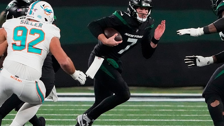 Nov 24, 2023; East Rutherford, New Jersey, USA; New York Jets quarterback Tim Boyle (7) scrambles against the Miami Dolphins in the second half at MetLife Stadium. Mandatory Credit: Robert Deutsch-USA TODAY Sports