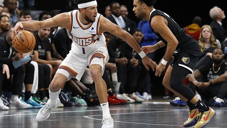 Nov 24, 2023; Memphis, Tennessee, USA; Phoenix Suns guard Devin Booker (1) dribbles as Memphis Grizzlies guard Jacob Gilyard (0) defends during the second half at FedExForum. Mandatory Credit: Petre Thomas-USA TODAY Sports