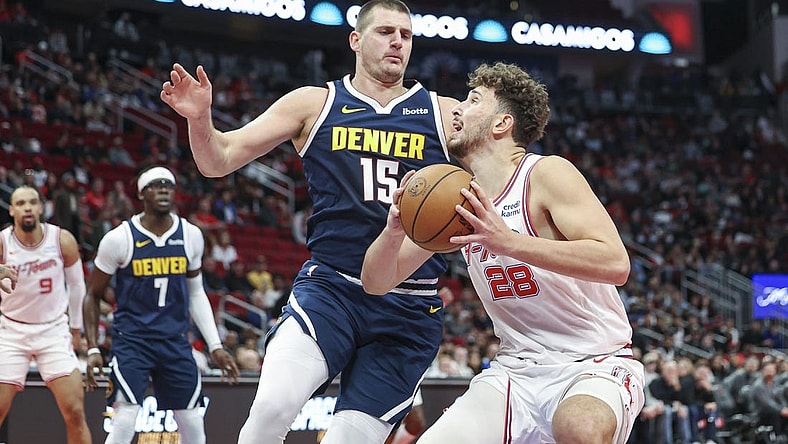 Nov 24, 2023; Houston, Texas, USA; Houston Rockets center Alperen Sengun (28) drives with the ball as Denver Nuggets center Nikola Jokic (15) defends during the first quarter at Toyota Center. Mandatory Credit: Troy Taormina-USA TODAY Sports