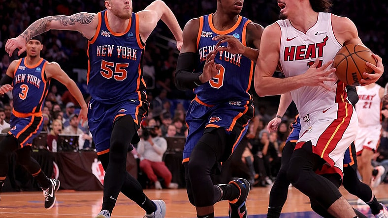Nov 24, 2023; New York, New York, USA; Miami Heat guard Jaime Jaquez Jr. (11) drives to the basket against New York Knicks guard RJ Barrett (9) and center Isaiah Hartenstein (55) during the second quarter at Madison Square Garden. Mandatory Credit: Brad Penner-USA TODAY Sports