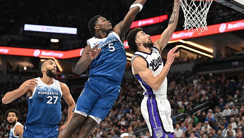Nov 24, 2023; Minneapolis, Minnesota, USA; Minnesota Timberwolves guard Anthony Edwards (5) blocks the shot of Sacramento Kings guard Chris Duarte (3) as center Rudy Gobert (27) looks on during the first quarter at Target Center. Mandatory Credit: Jeffrey Becker-USA TODAY Sports