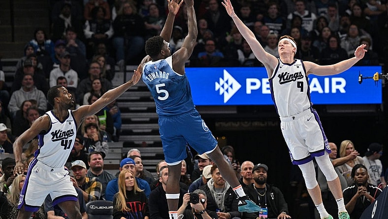 Nov 24, 2023; Minneapolis, Minnesota, USA; Sacramento Kings forward Harrison Barnes (40) and guard Kevin Huerter (9) defend the shot of Minnesota Timberwolves guard Anthony Edwards (5) during the first quarter at Target Center. Mandatory Credit: Jeffrey Becker-USA TODAY Sports