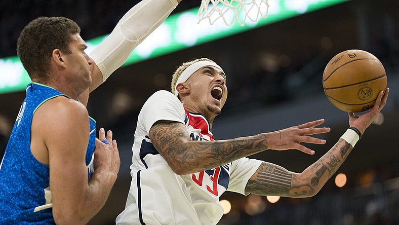 Nov 24, 2023; Milwaukee, Wisconsin, USA;  Washington Wizards forward Kyle Kuzma (33) shoots against Milwaukee Bucks center Brook Lopez (11) during the second quarter at Fiserv Forum. Mandatory Credit: Jeff Hanisch-USA TODAY Sports