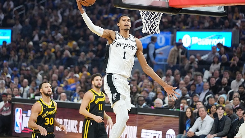 November 24, 2023; San Francisco, California, USA; San Antonio Spurs center Victor Wembanyama (1) dunks the basketball against Golden State Warriors guard Stephen Curry (30) and guard Klay Thompson (11) during the first quarter at Chase Center. Mandatory Credit: Kyle Terada-USA TODAY Sports
