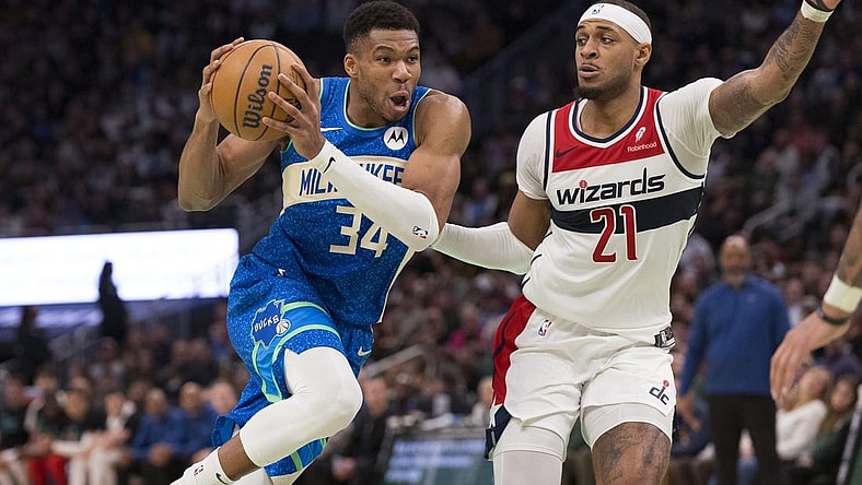 Nov 24, 2023; Milwaukee, Wisconsin, USA;  Milwaukee Bucks forward Giannis Antetokounmpo (34) drives for the basket against Washington Wizards center Daniel Gafford (21) during the fourth quarter at Fiserv Forum. Mandatory Credit: Jeff Hanisch-USA TODAY Sports