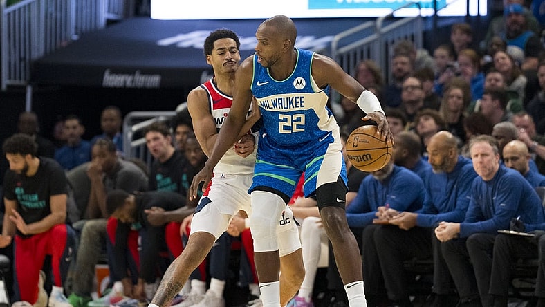 Nov 24, 2023; Milwaukee, Wisconsin, USA;  Milwaukee Bucks forward Khris Middleton (22) dribbles the ball as Washington Wizards guard Jordan Poole (13) defends during the first quarter at Fiserv Forum. Mandatory Credit: Jeff Hanisch-USA TODAY Sports
