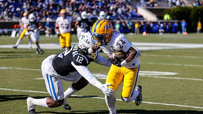 Nov 25, 2023; Durham, North Carolina, USA; Duke Blue Devils linebacker Tre Freeman (12) tacks Pittsburgh Panthers running back C'Bo Flemister (24) during the first half of the game at Wallace Wade Stadium. Mandatory Credit: Jaylynn Nash-USA TODAY Sports