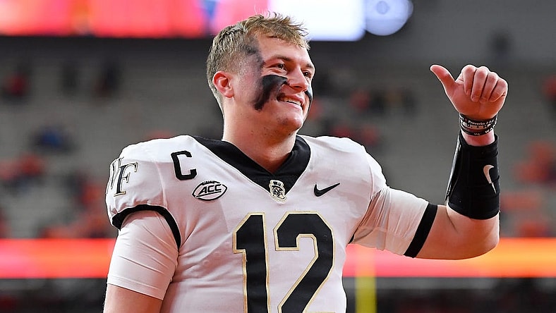 Nov 25, 2023; Syracuse, New York, USA; Wake Forest Demon Deacons quarterback Mitch Griffis (12) gestures to fans prior to the game against the Syracuse Orange at the JMA Wireless Dome. Mandatory Credit: Rich Barnes-USA TODAY Sports