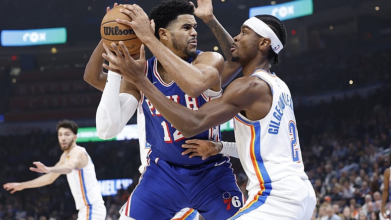 Nov 25, 2023; Oklahoma City, Oklahoma, USA; Oklahoma City Thunder guard Shai Gilgeous-Alexander (2) defends a drive by Philadelphia 76ers forward Tobias Harris (12) during the first quarter at Paycom Center. Mandatory Credit: Alonzo Adams-USA TODAY Sports