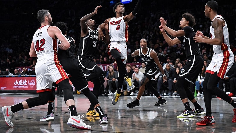 Nov 25, 2023; Brooklyn, New York, USA; Miami Heat guard Josh Richardson (0) drives to the basket against Brooklyn Nets forward Dorian Finney-Smith (28) and  guard Lonnie Walker IV (8) and forward Cameron Johnson (2) during the second quarter at Barclays Center. Mandatory Credit: John Jones-USA TODAY Sports