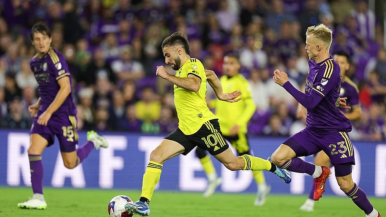 Nov 25, 2023; Orlando, Florida, USA; Columbus Crew forward Diego Rossi (10) dribbles the ball as Orlando City midfielder Dagur Dan Thorhallsson (23) defends during the second half in a MLS Cup Eastern Conference Semifinal match at Exploria Stadium. Mandatory Credit: Nathan Ray Seebeck-USA TODAY Sports