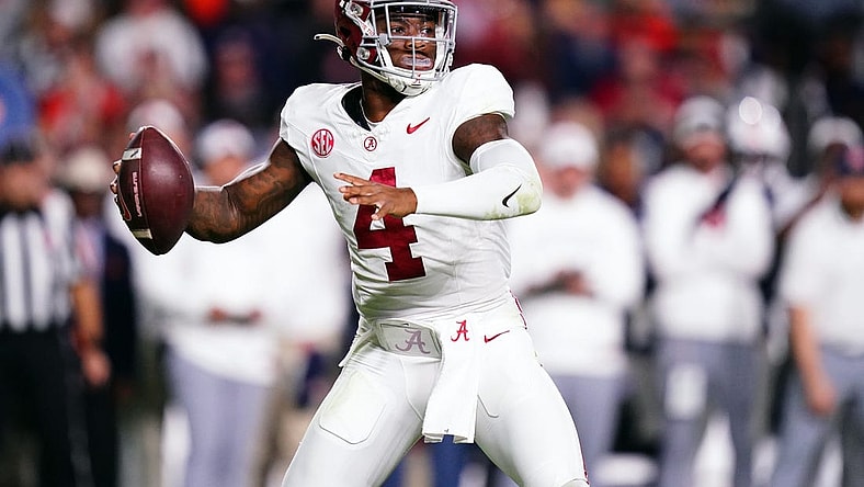 Nov 25, 2023; Auburn, Alabama, USA; Alabama Crimson Tide quarterback Jalen Milroe (4) drops back to pass against the Auburn Tigers during the fourth quarter at Jordan-Hare Stadium. Mandatory Credit: John David Mercer-USA TODAY Sports