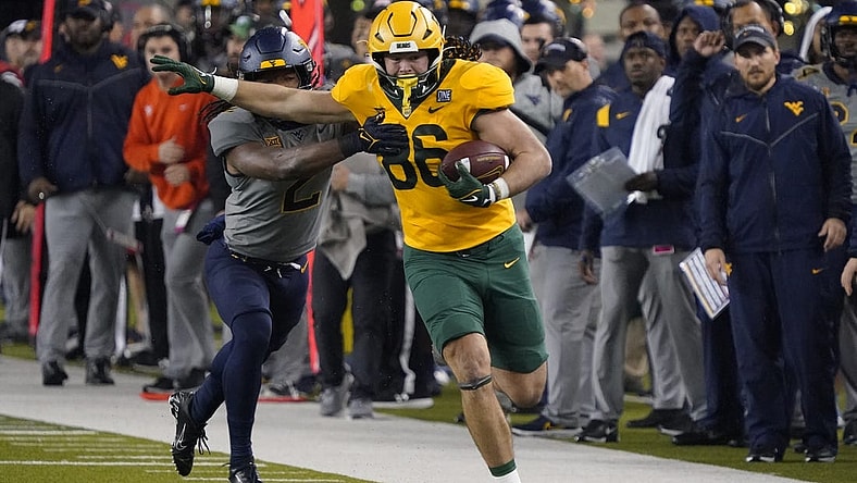 Nov 25, 2023; Waco, Texas, USA; Baylor Bears tight end Jake Roberts (86) runs after the catch past  West Virginia Mountaineers safety Aubrey Burks (2) during the first half at McLane Stadium. Mandatory Credit: Raymond Carlin III-USA TODAY Sports