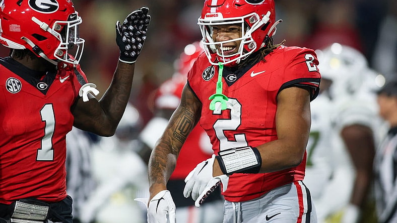 Nov 25, 2023; Atlanta, Georgia, USA; Georgia Bulldogs running back Kendall Milton (2) celebrates with wide receiver Marcus Rosemy-Jacksaint (1) after a touchdown against the Georgia Tech Yellow Jackets in the second quarter at Bobby Dodd Stadium at Hyundai Field. Mandatory Credit: Brett Davis-USA TODAY Sports