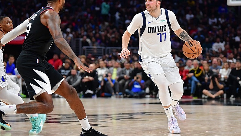 Nov 25, 2023; Los Angeles, California, USA; Dallas Mavericks guard Luka Doncic (77) controls the ball against the Los Angeles Clippers during the second half Crypto.com Arena. Mandatory Credit: Gary A. Vasquez-USA TODAY Sports