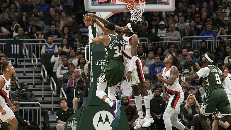 Nov 26, 2023; Milwaukee, Wisconsin, USA;  Portland Trail Blazers forward Jerami Grant (9) defends Milwaukee Bucks forward Giannis Antetokounmpo (34) during the fourth quarter at Fiserv Forum. Mandatory Credit: Jeff Hanisch-USA TODAY Sports
