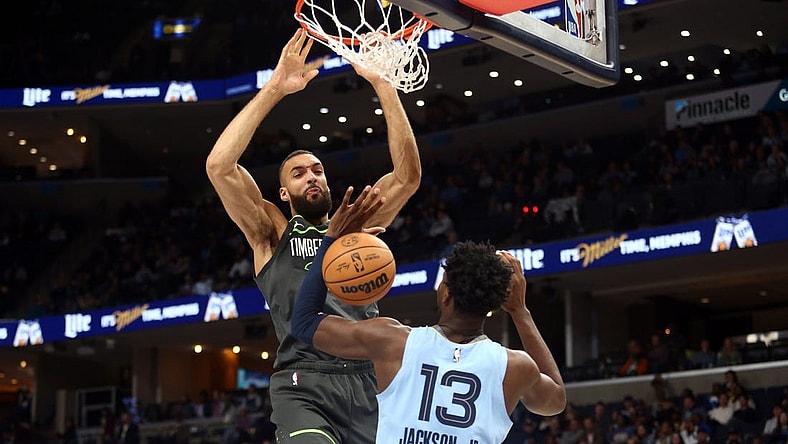 Nov 24, 2023; Memphis, Tennessee, USA; Minnesota Timberwolves center Rudy Gobert (27) dunks over Memphis Grizzlies forward-center Jaren Jackson Jr. (13) during the first half at FedExForum. Mandatory Credit: Petre Thomas-USA TODAY Sports