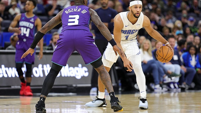 Nov 26, 2023; Orlando, Florida, USA;  Orlando Magic guard Jalen Suggs (4) is guarded by Charlotte Hornets guard Terry Rozier (3) in the second quarter at Amway Center. Mandatory Credit: Nathan Ray Seebeck-USA TODAY Sports