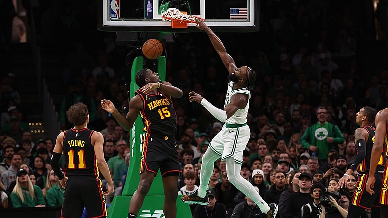 Nov 26, 2023; Boston, Massachusetts, USA; Boston Celtics guard Jaylen Brown (7) dunks over Atlanta Hawks center Clint Capela (15) during the second quarter at TD Garden. Mandatory Credit: Winslow Townson-USA TODAY Sports