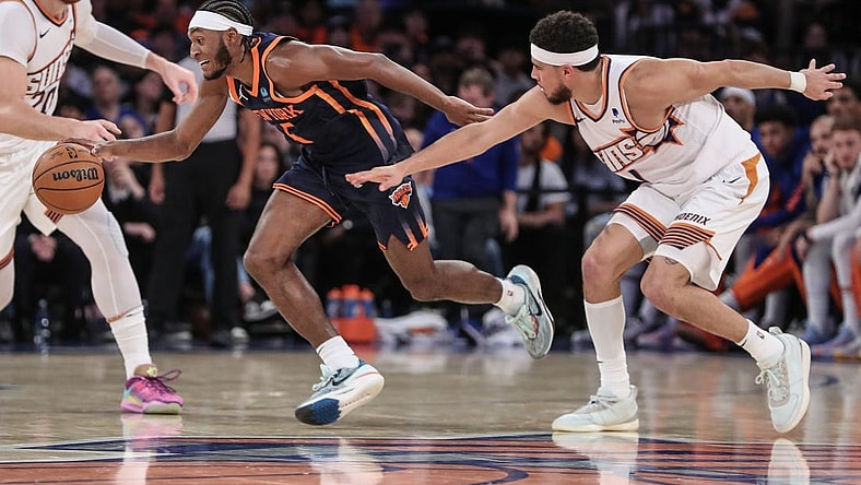Nov 26, 2023; New York, New York, USA; New York Knicks guard Immanuel Quickley (5) steals the ball from Phoenix Suns guard Devin Booker (1) in the fourth quarter at Madison Square Garden. Mandatory Credit: Wendell Cruz-USA TODAY Sports