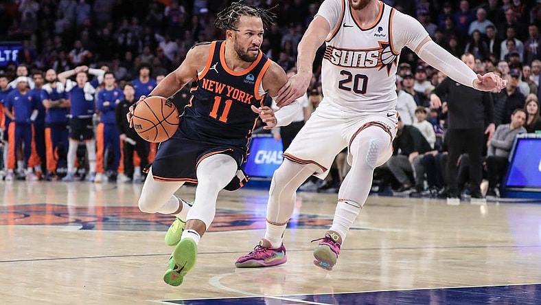 Nov 26, 2023; New York, New York, USA; New York Knicks guard Jalen Brunson (11) drives past Phoenix Suns center Jusuf Nurkic (20) in the fourth quarter at Madison Square Garden. Mandatory Credit: Wendell Cruz-USA TODAY Sports