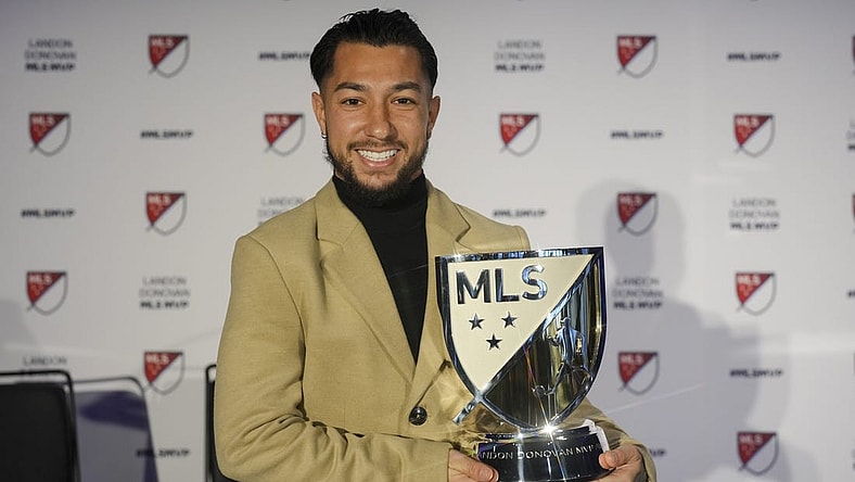 Nov 27, 2023; Cincinnati, OH, USA;  FC Cincinnati   s Luciano Acosta poses for a photo with the Landon Donovan MLS MVP award during a press conference at TQL Stadium. Mandatory Credit: Aaron Doster-USA TODAY Sports