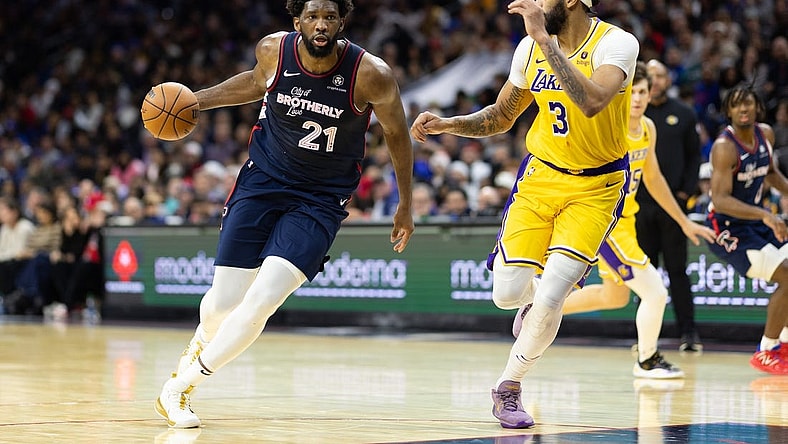 Nov 27, 2023; Philadelphia, Pennsylvania, USA; Philadelphia 76ers center Joel Embiid (21) dribbles the ball against Los Angeles Lakers forward Anthony Davis (3) during the third quarter at Wells Fargo Center. Mandatory Credit: Bill Streicher-USA TODAY Sports