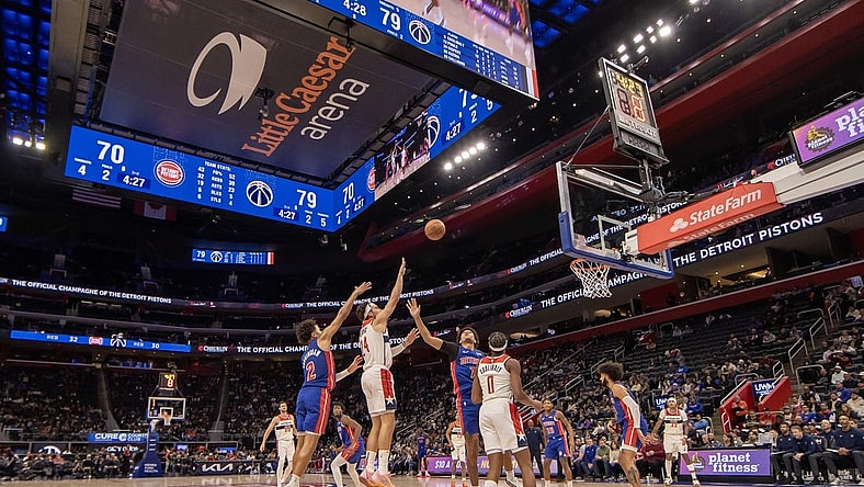 Nov 27, 2023; Detroit, Michigan, USA; Washington Wizards forward Corey Kispert (24) shoots the ball between Detroit Pistons guard Cade Cunningham (2) and guard Killian Hayes (7) during the second half at Little Caesars Arena. Mandatory Credit: David Reginek-USA TODAY Sports