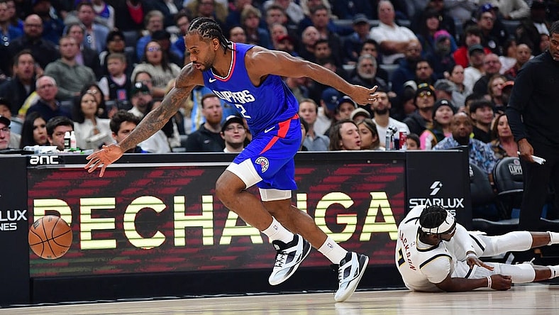 Nov 27, 2023; Los Angeles, California, USA; Los Angeles Clippers forward Kawhi Leonard (2) steals the ball from Denver Nuggets guard Reggie Jackson (7) during the first half at Crypto.com Arena. Mandatory Credit: Gary A. Vasquez-USA TODAY Sports