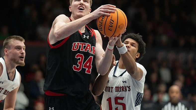 Nov 27, 2023; Moraga, California, USA;  Utah Utes center Lawson Lovering (34) attempts to shoot the ball during the first half against St. Mary's Gaels guard Chris Howell (15) at University Credit Union Pavilion. Mandatory Credit: Stan Szeto-USA TODAY Sports