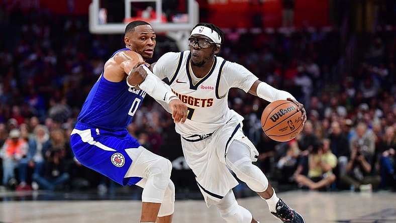 Nov 27, 2023; Los Angeles, California, USA; Denver Nuggets guard Reggie Jackson (7) moves the ball against Los Angeles Clippers guard Russell Westbrook (0) during the second half at Crypto.com Arena. Mandatory Credit: Gary A. Vasquez-USA TODAY Sports