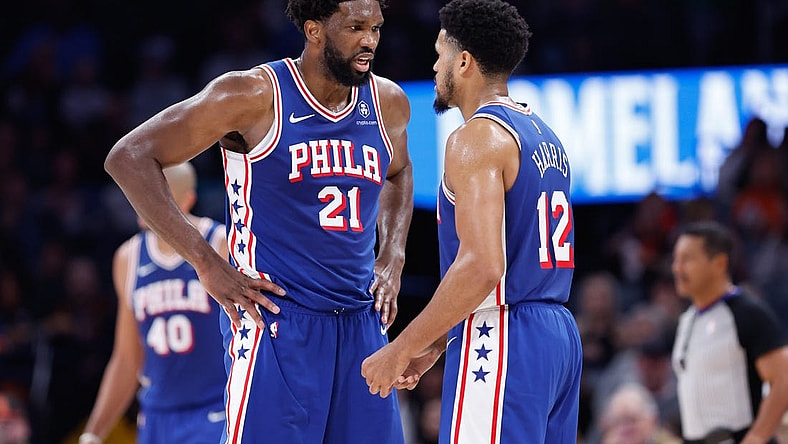 Nov 25, 2023; Oklahoma City, Oklahoma, USA; Philadelphia 76ers center Joel Embiid (21) and forward Tobias Harris (12) talk between plays against the Oklahoma City Thunder during the second half at Paycom Center. Mandatory Credit: Alonzo Adams-USA TODAY Sports